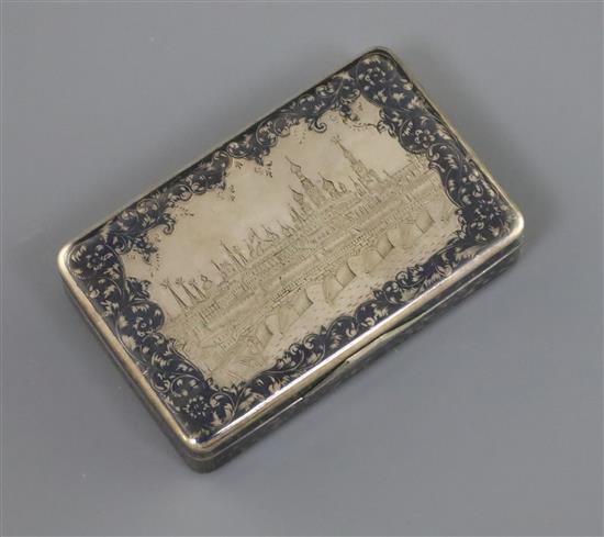 A 19th century Russian 84 zolotnik silver and niello work snuff box, decorated with a view of the Kremlin, Moscow, 79mm.